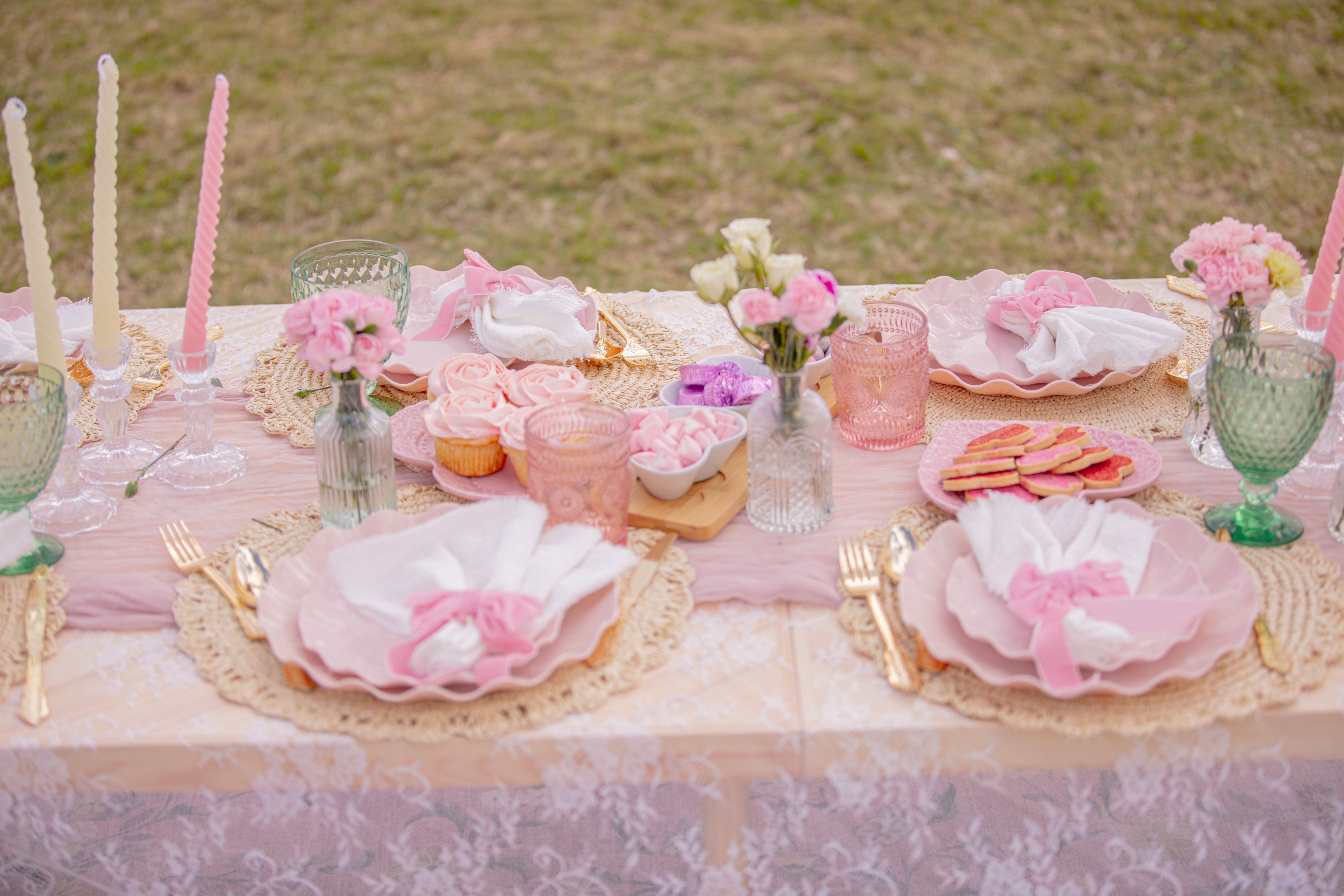 Pink table setting with cupcakes and candles