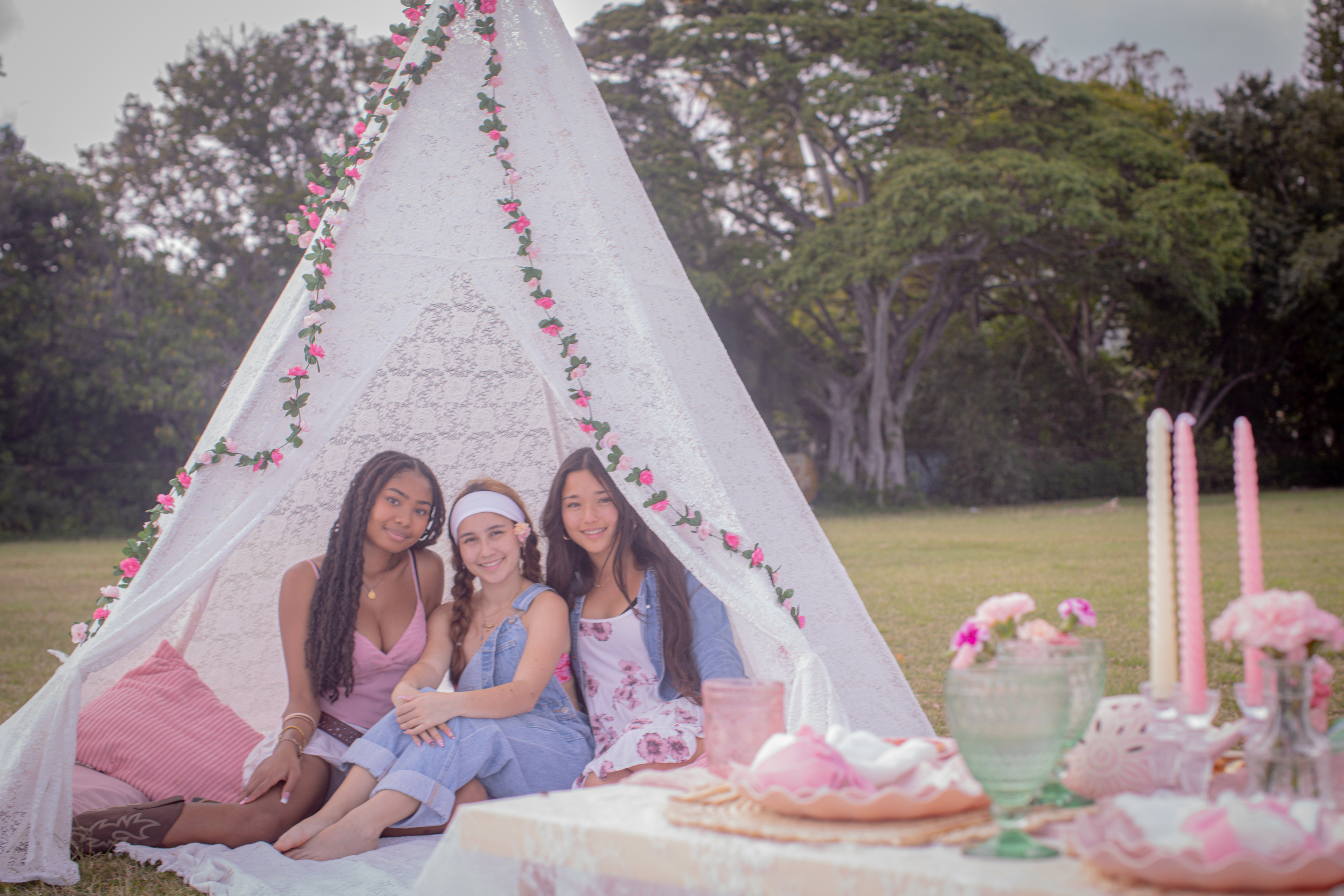Friends enjoying a teepee picnic